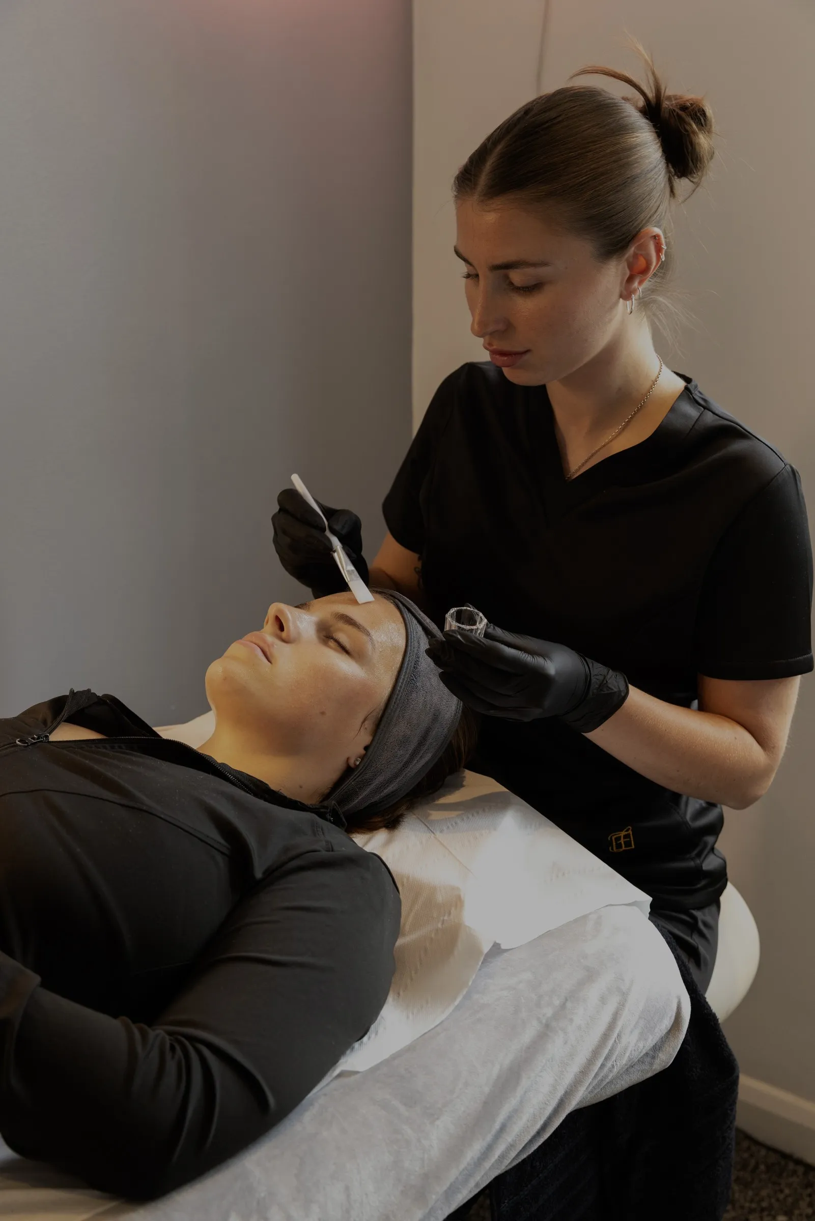 Evie treating a client at Ej's Beauty